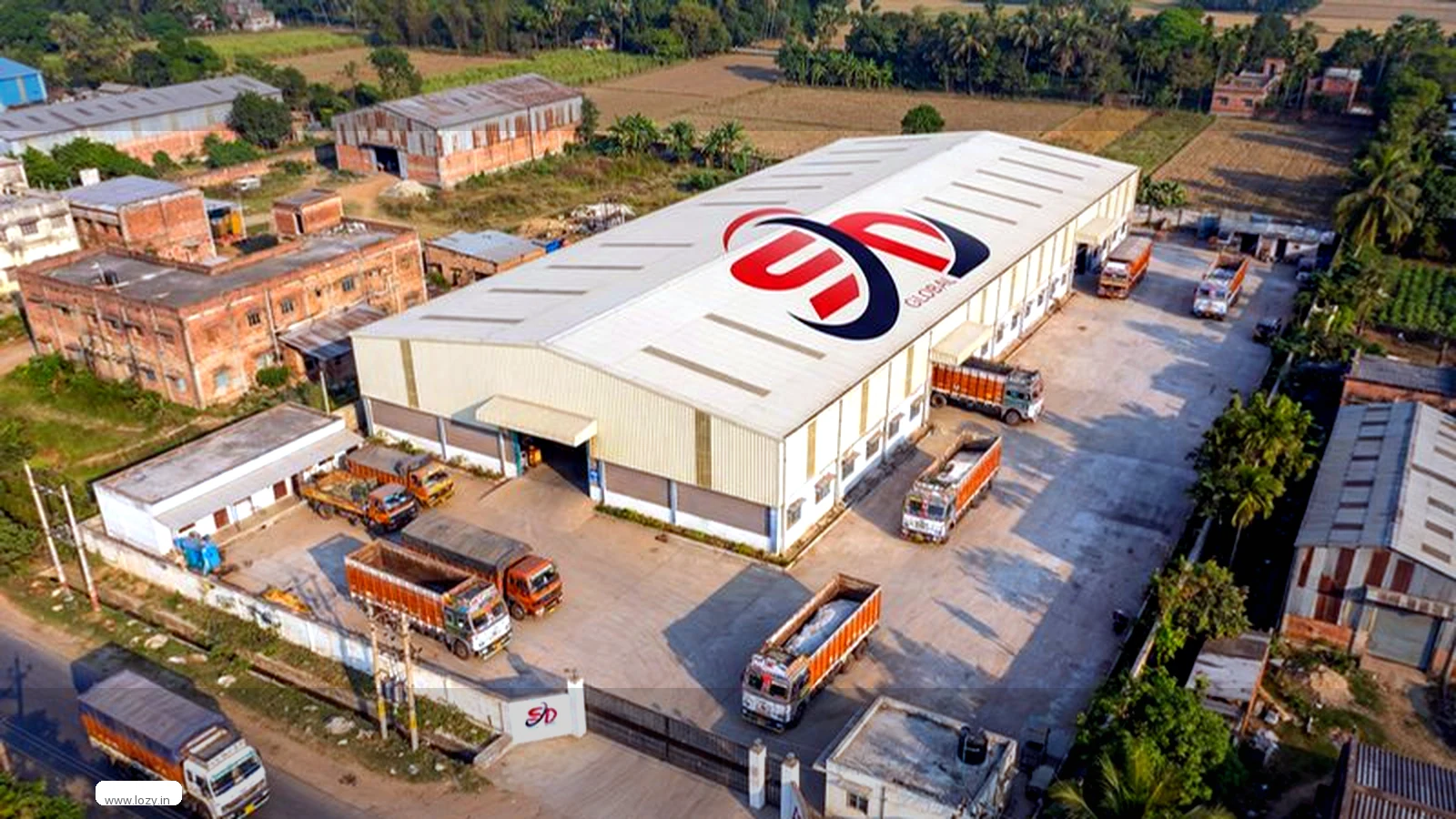 Godown warehouse complex with racked storage and a paved truck yard on the Mumbai-Nashik corridor near Bhiwandi, Maharashtra