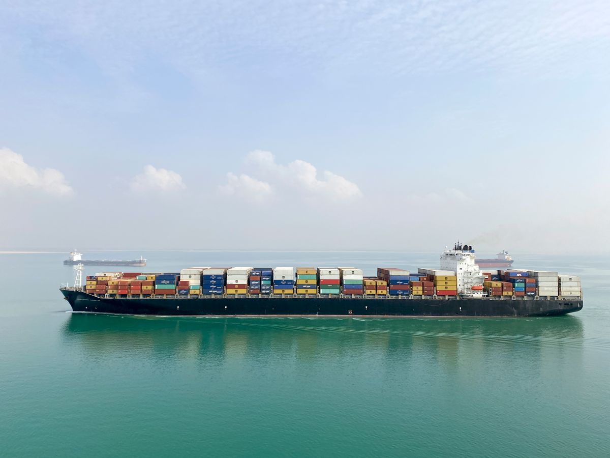 Container ship at sea carrying stacked shipping containers